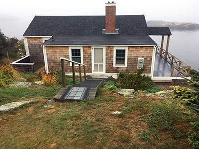 View of house including porch and roof