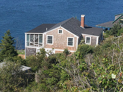 View of house including porch and roof