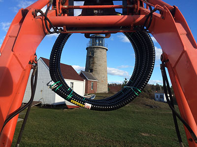 backhoe carrying insulated line